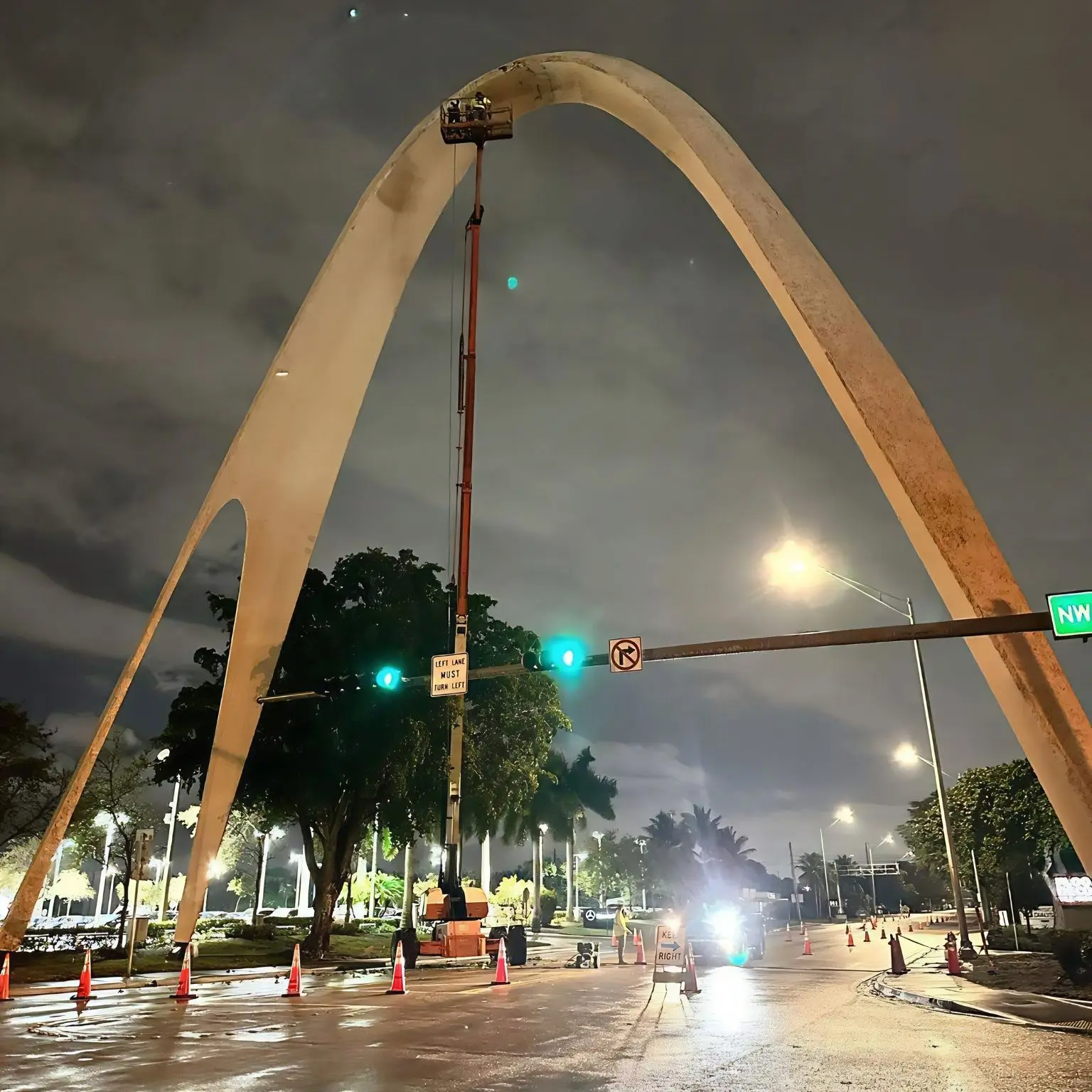 MTD crew restoring the Sunshine State Arch at night with a boom lift