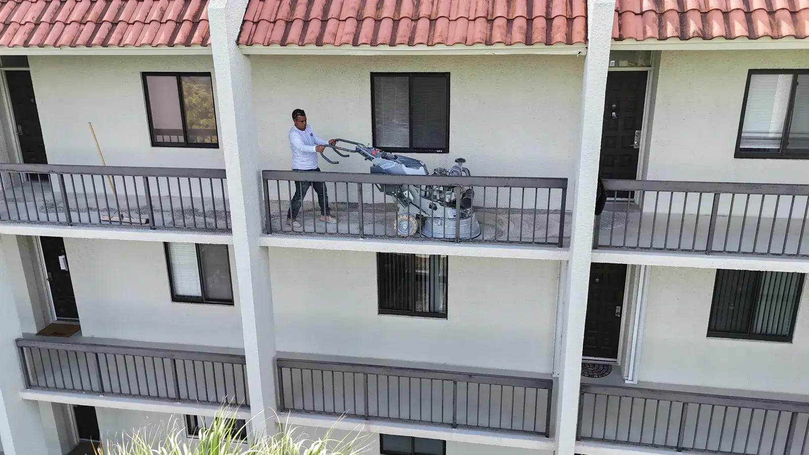 MTD crew preparing a condo walkway slab during concrete restoration